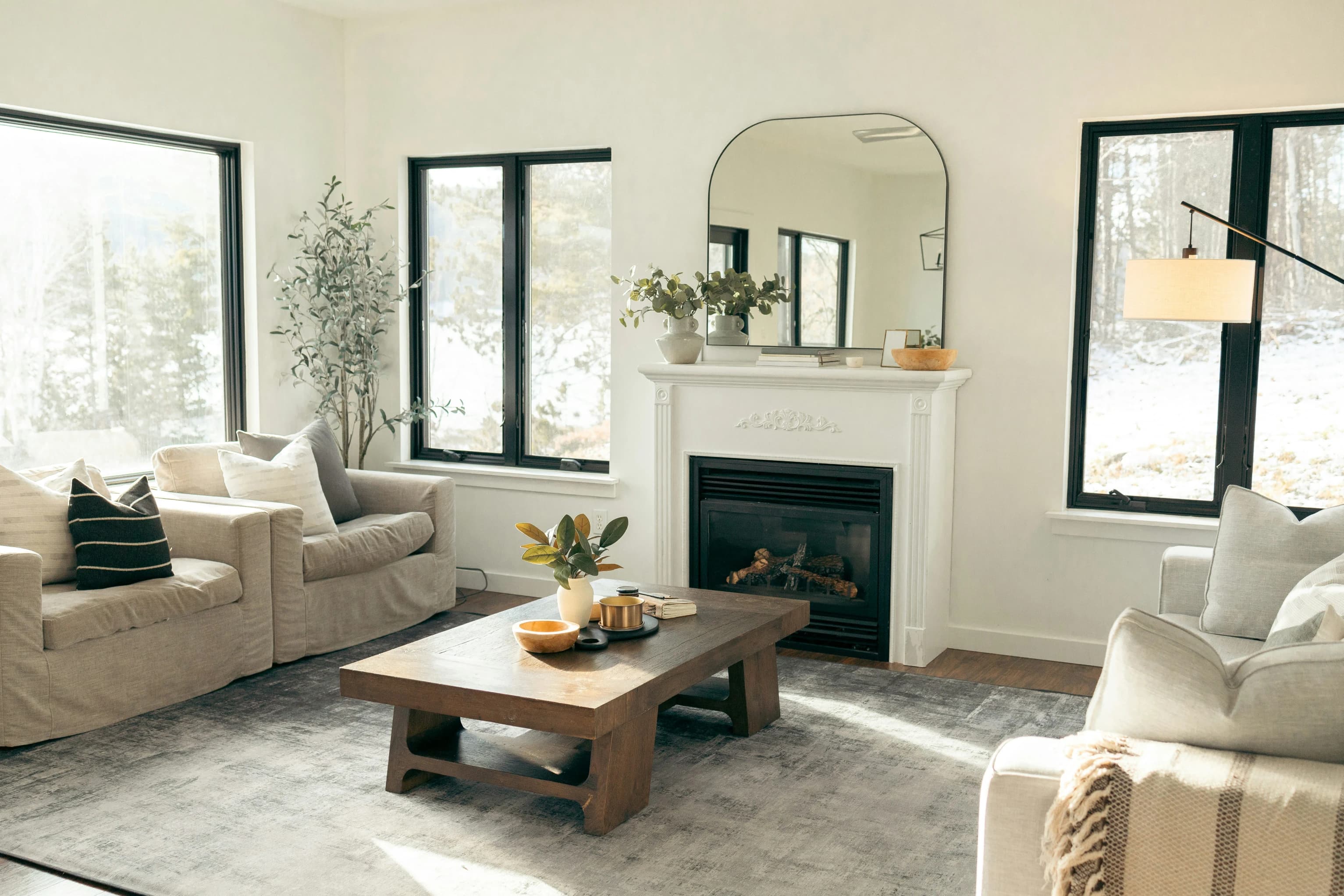 Bright, tidy living room with fireplace maintained by KM Fine Homes
